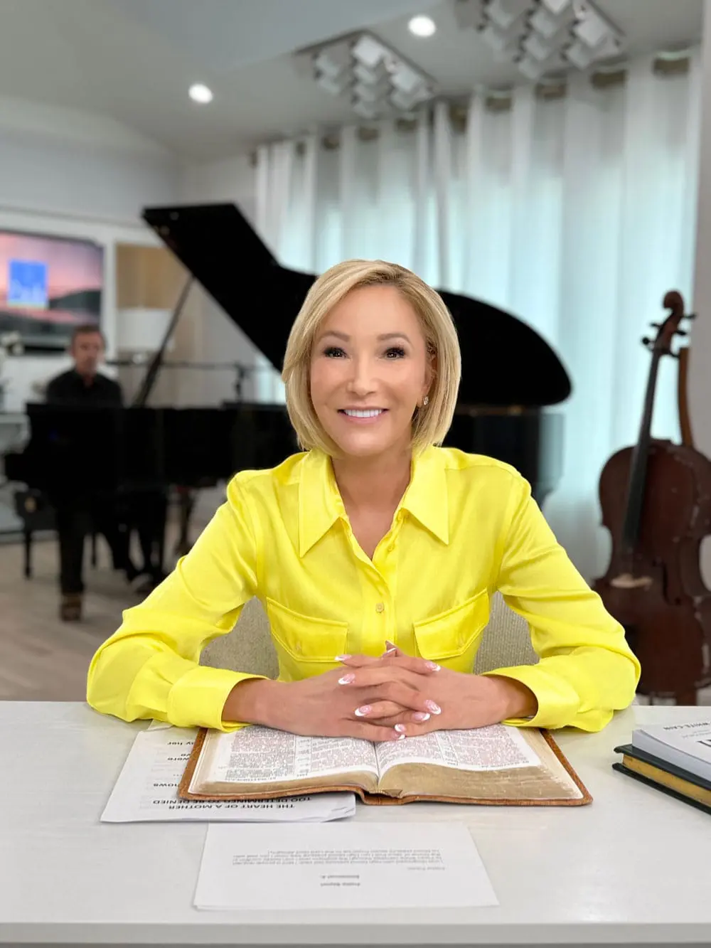 Paula White sitting in studio during Paula White Ministries recording or broadcast session