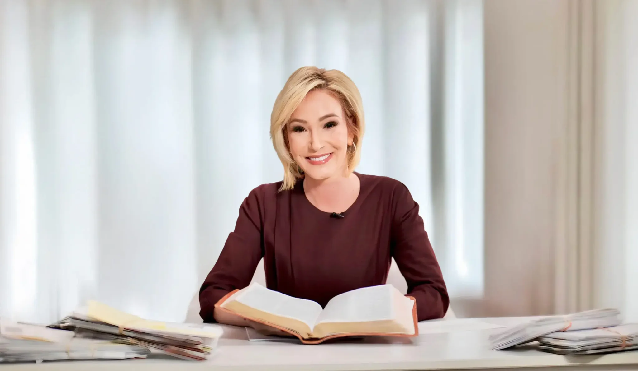 Paula White seated at a desk, teaching as part of Paula White Ministries