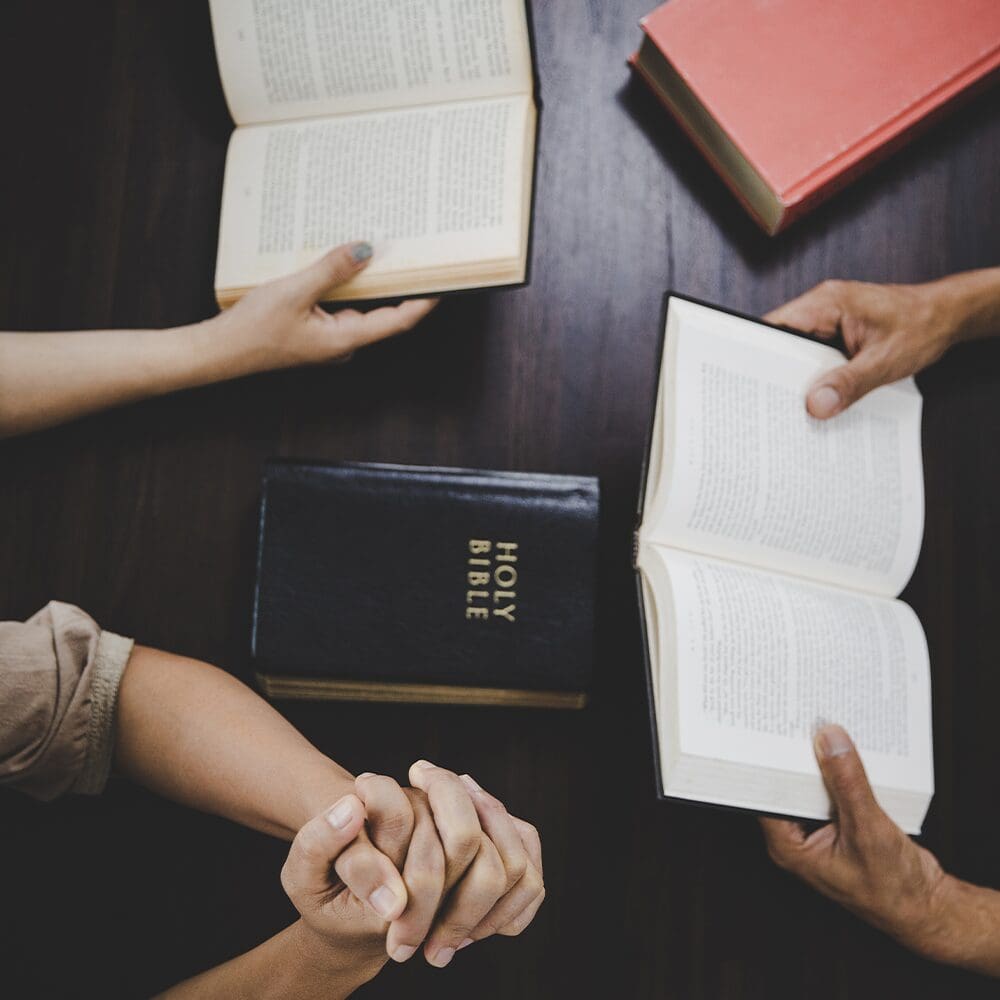 Group reading Bibles together during Bible study session